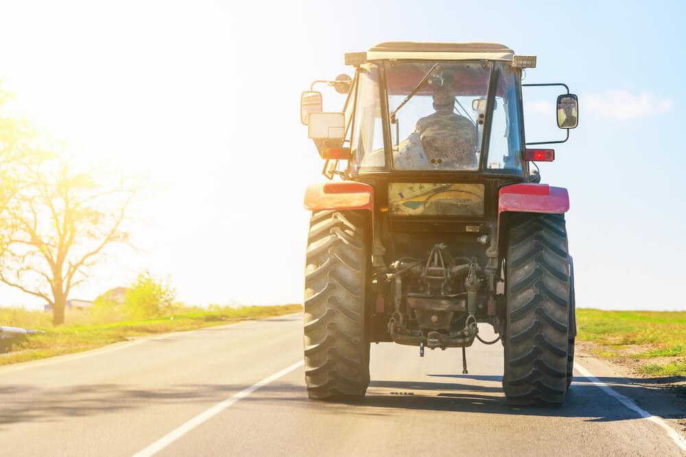 Man driving a tractor down the road