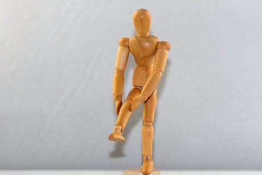 wooden art model showing knee injury